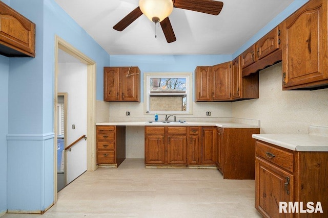 kitchen featuring decorative backsplash, ceiling fan, and sink