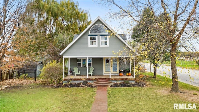 bungalow-style house with a front yard and covered porch