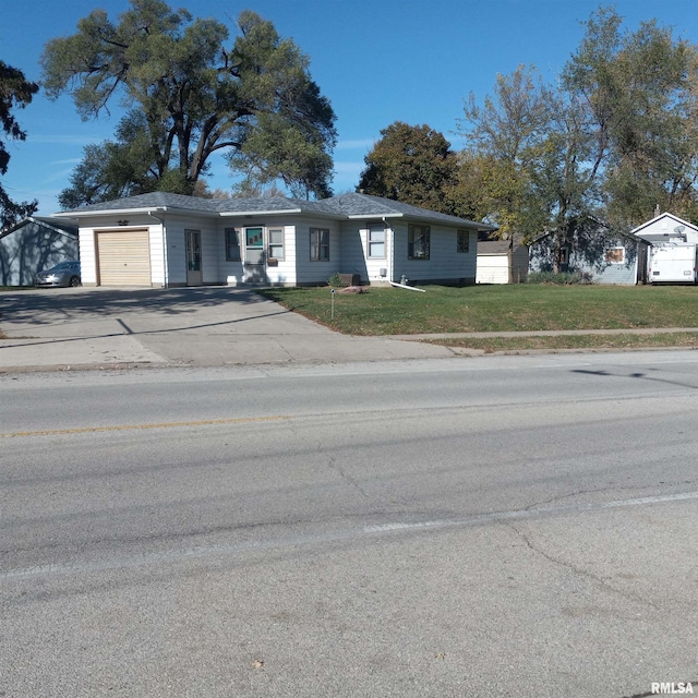 single story home featuring a garage and a front yard