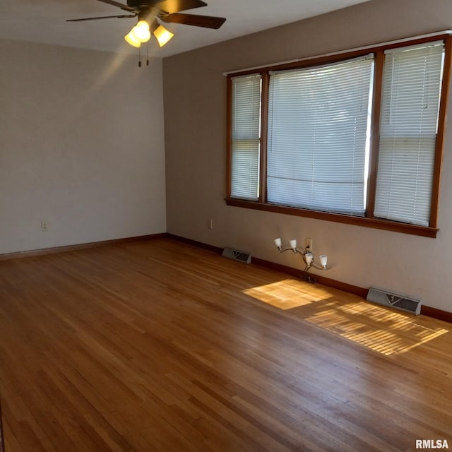 spare room with hardwood / wood-style flooring and ceiling fan