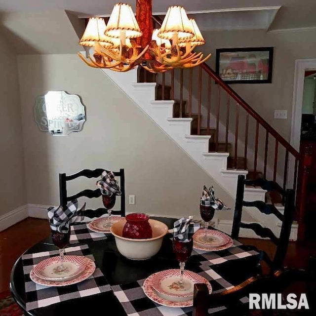 dining space featuring ornamental molding and a notable chandelier