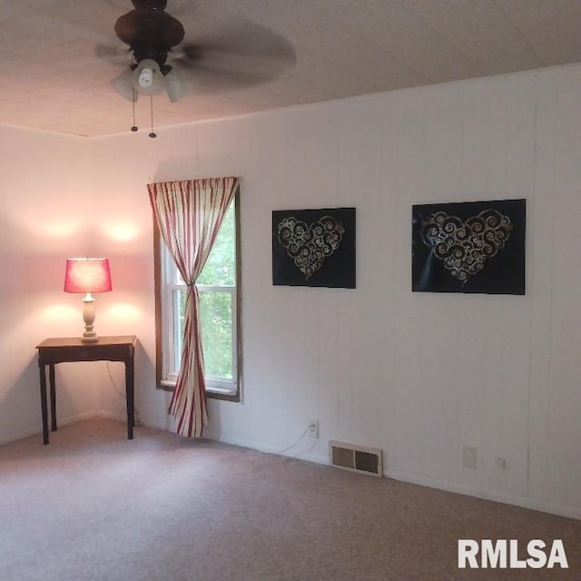 empty room with carpet flooring and ceiling fan