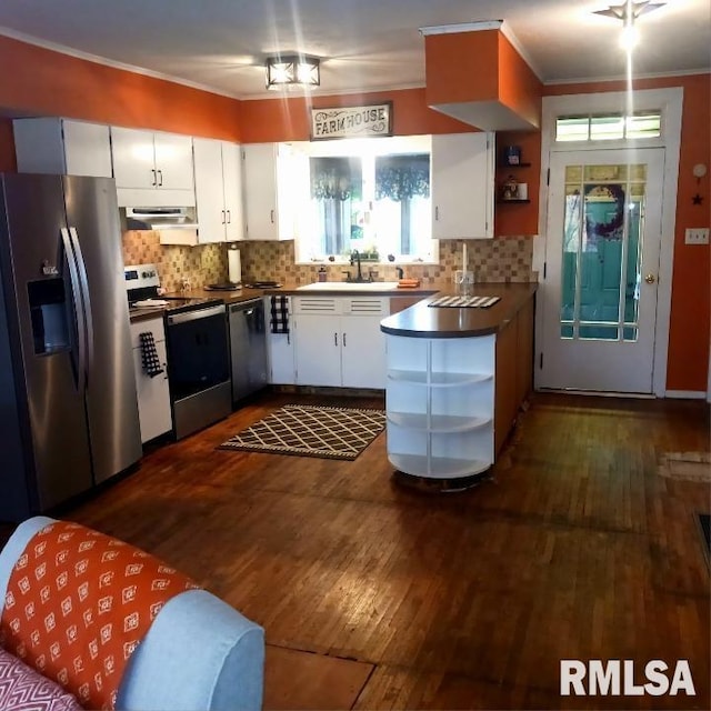 kitchen with dark hardwood / wood-style flooring, extractor fan, appliances with stainless steel finishes, and white cabinets