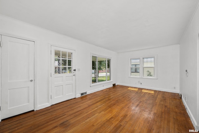 interior space with hardwood / wood-style floors and ornamental molding