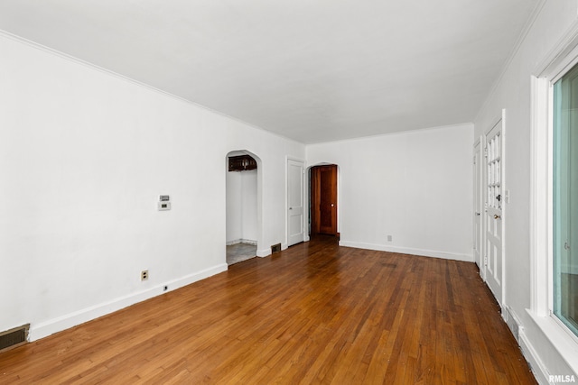 spare room with hardwood / wood-style flooring and ornamental molding