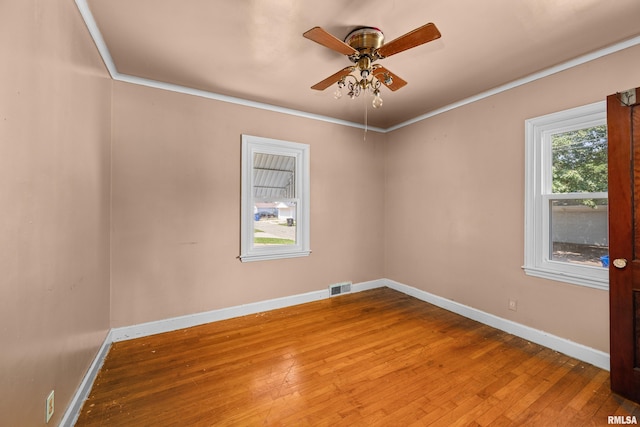 unfurnished room with ceiling fan, wood-type flooring, and ornamental molding