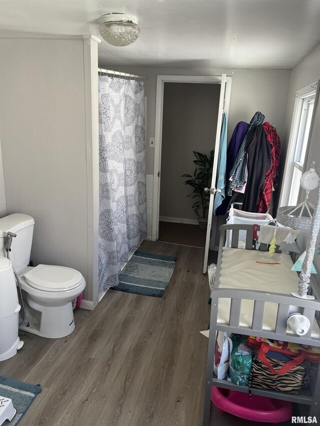 443 4th Ave N, Clinton, IA 52732 - bathroom featuring wood finished floors and a shower with shower curtain