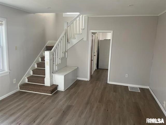 staircase featuring wood-type flooring and ornamental molding