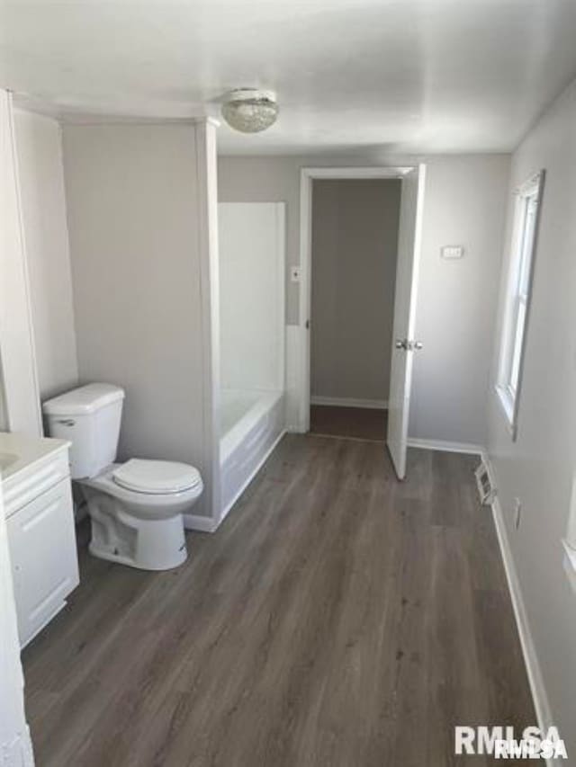 bathroom with vanity, hardwood / wood-style flooring, and toilet