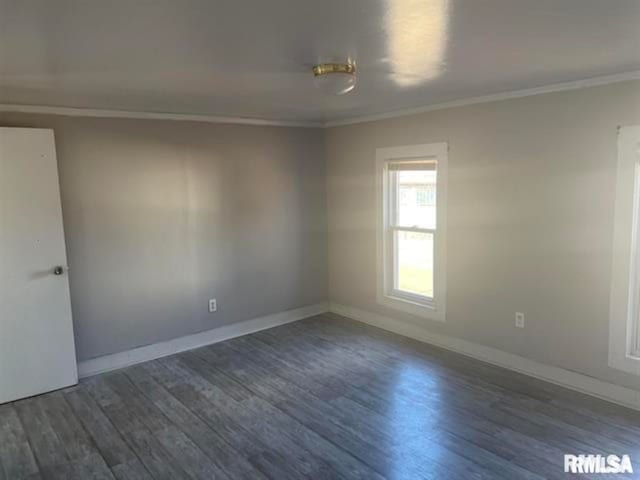 empty room with dark hardwood / wood-style floors and ornamental molding