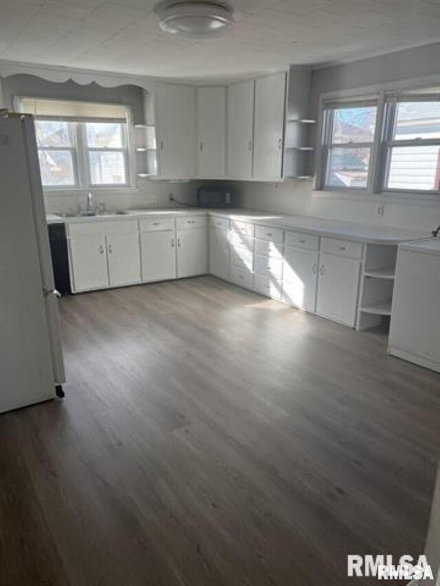 443 4th Ave N, Clinton, IA 52732 - kitchen featuring open shelves, freestanding refrigerator, wood finished floors, and white cabinetry