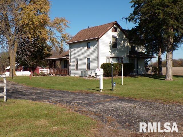 view of side of property with a lawn and cooling unit