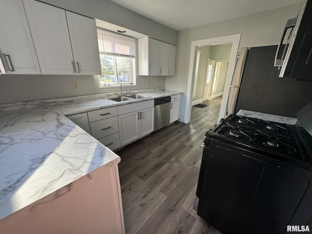 kitchen with black gas range, dishwasher, white cabinets, sink, and dark hardwood / wood-style floors