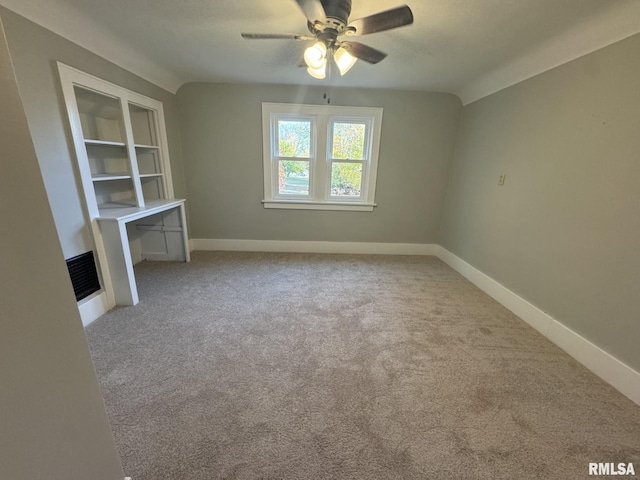 carpeted spare room with ceiling fan