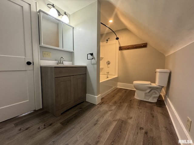 full bathroom featuring wood-type flooring, vanity, tub / shower combination, vaulted ceiling, and toilet