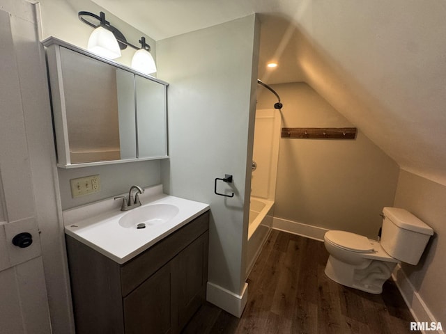 full bathroom featuring hardwood / wood-style flooring, tub / shower combination, vanity, toilet, and vaulted ceiling