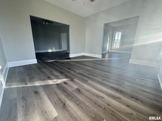 spare room with dark hardwood / wood-style flooring and ceiling fan