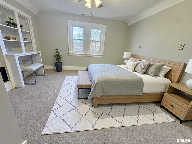 bedroom with visible vents, baseboards, light colored carpet, ceiling fan, and vaulted ceiling