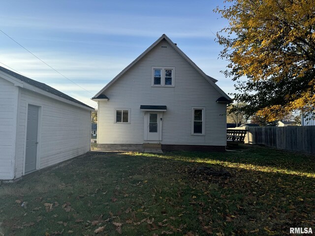 rear view of house with a yard