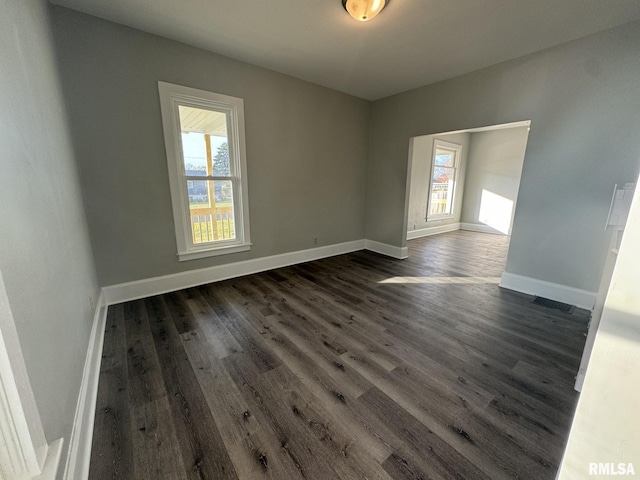 empty room with dark hardwood / wood-style floors