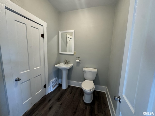 bathroom featuring hardwood / wood-style floors, toilet, and sink