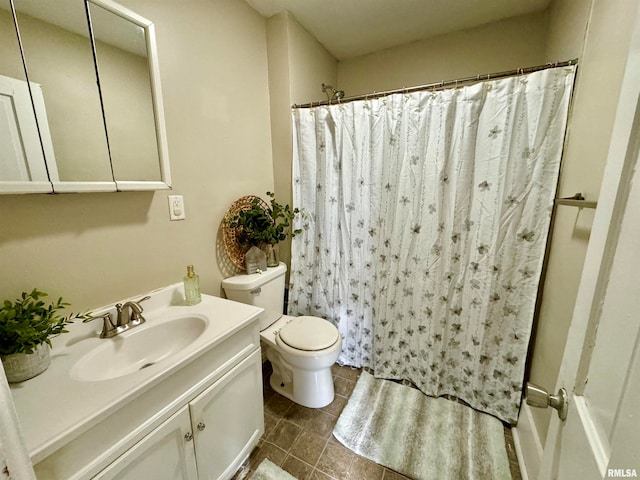 bathroom with curtained shower, tile patterned floors, vanity, and toilet