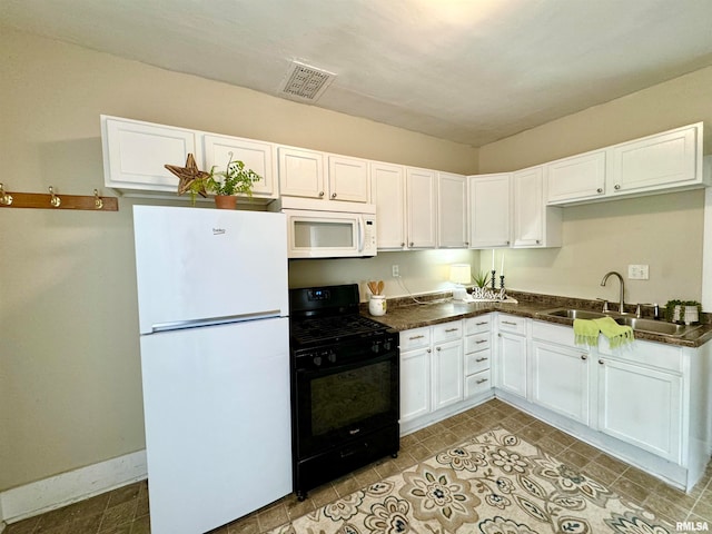 kitchen featuring white appliances, white cabinetry, and sink