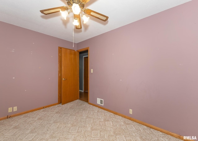 unfurnished room featuring light colored carpet and ceiling fan