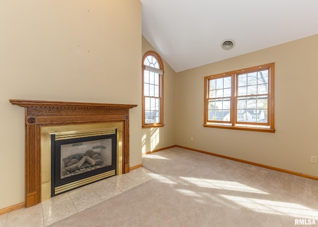 unfurnished living room with light colored carpet and lofted ceiling