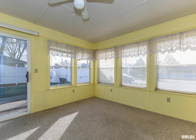 unfurnished sunroom with ceiling fan