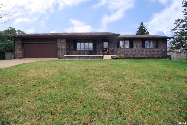 view of front of property featuring a garage and a front yard