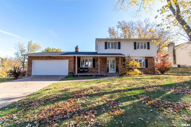 view of property featuring a garage, a porch, and a front lawn