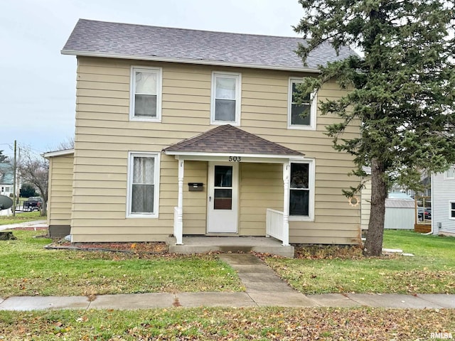 view of front of property featuring a front lawn and covered porch