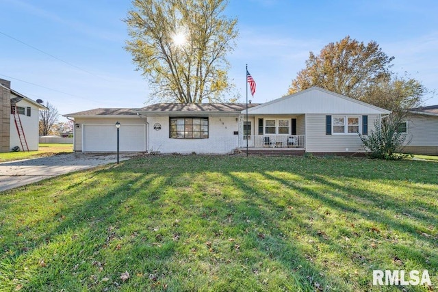 ranch-style home featuring a garage, covered porch, and a front lawn