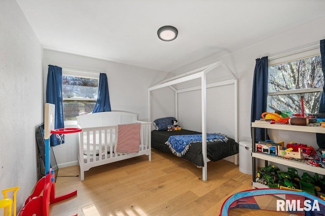 bedroom with hardwood / wood-style floors