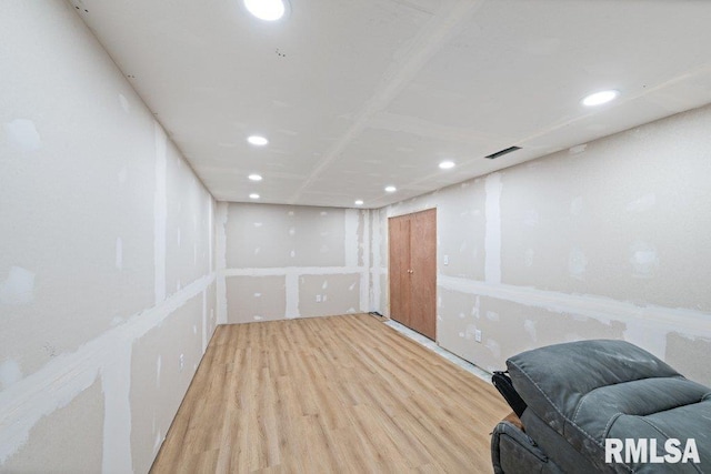 basement with light hardwood / wood-style floors