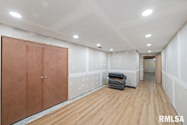 basement with light hardwood / wood-style floors