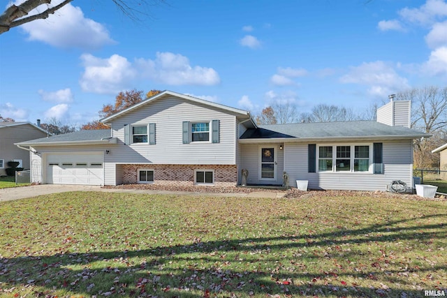 tri-level home with a garage and a front yard