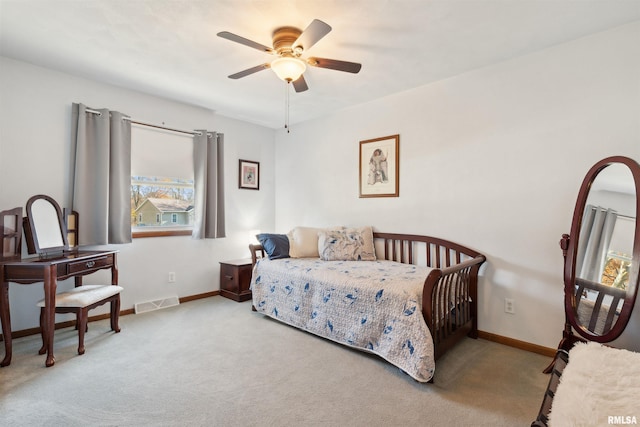 bedroom featuring multiple windows, ceiling fan, and light carpet