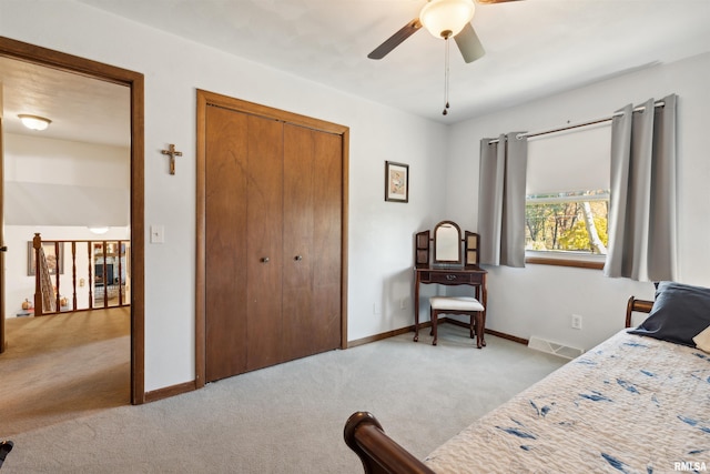 carpeted bedroom featuring ceiling fan and a closet