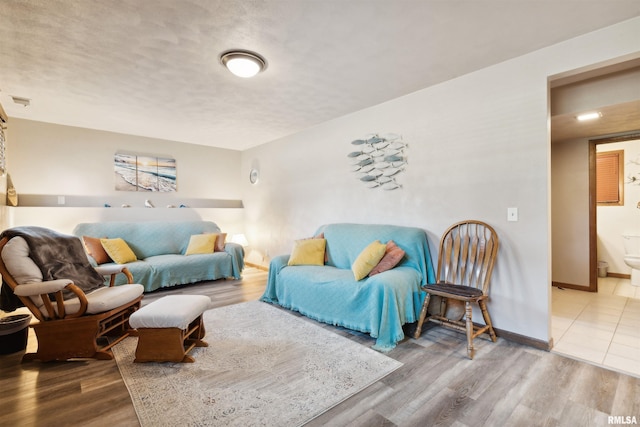 living room featuring hardwood / wood-style floors and a textured ceiling