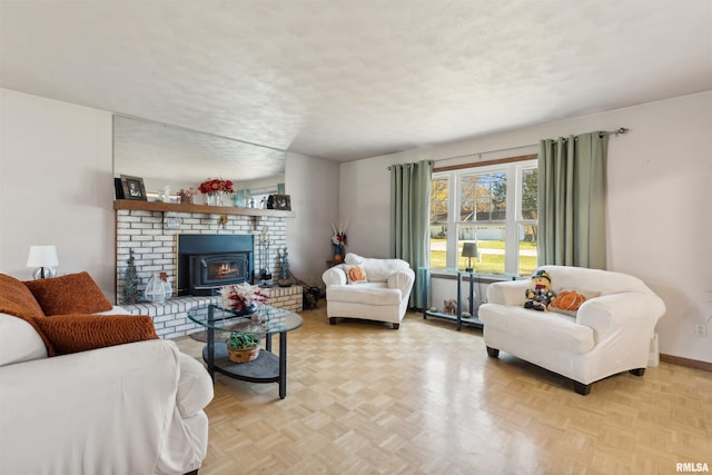 living room featuring a wood stove, light parquet floors, and a textured ceiling