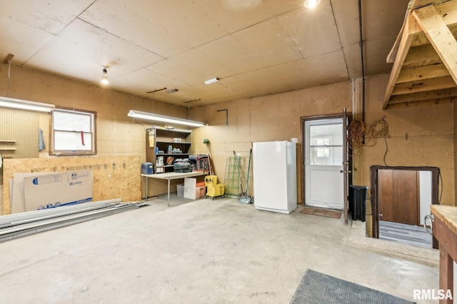 basement with white fridge