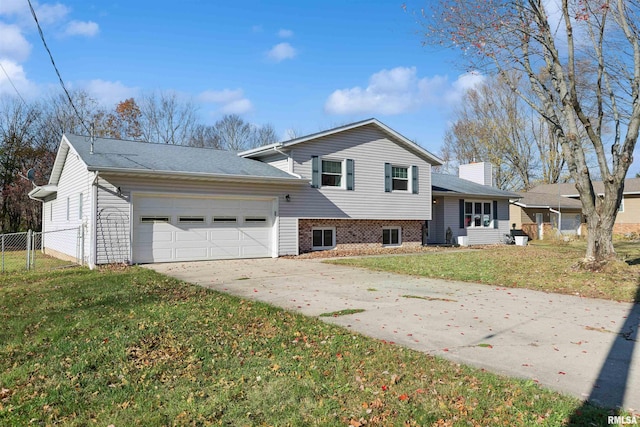 split level home with a garage and a front lawn