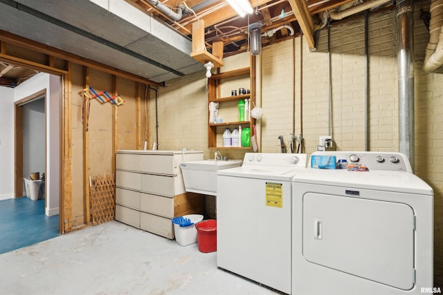 clothes washing area featuring separate washer and dryer