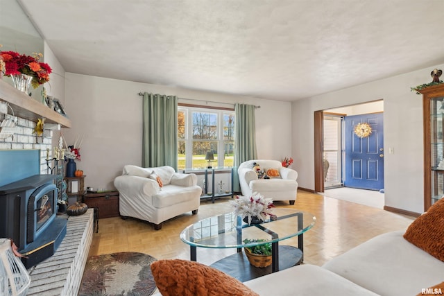 living room with light parquet floors and a wood stove