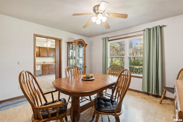 dining space featuring ceiling fan and light parquet floors