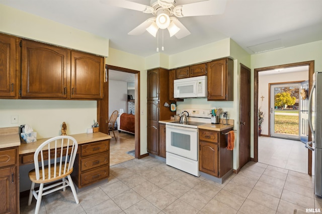 kitchen featuring ceiling fan, light tile patterned floors, and white appliances