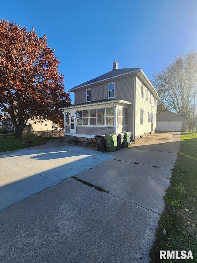 view of front of house with an outbuilding and a garage