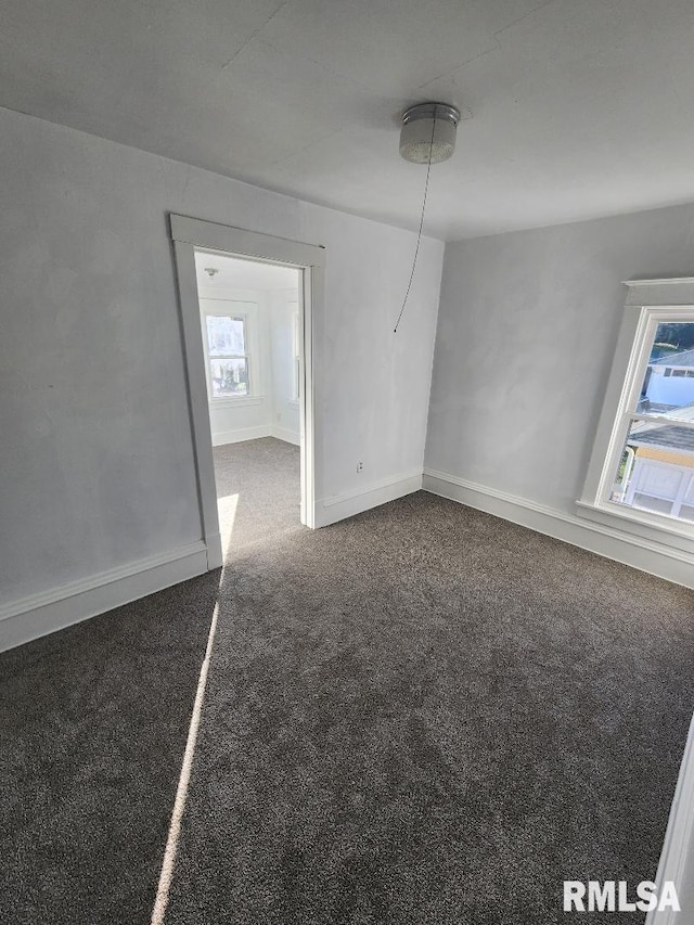 carpeted empty room with a wealth of natural light